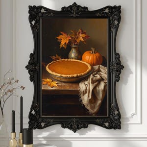 May include: A framed still life painting featuring a pumpkin pie, a small orange pumpkin, and a vase of autumn leaves. The pie is in a glass pie dish. The frame is black and ornate.