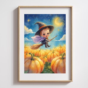 May include: A framed print showing a baby witch on a broomstick, flying over pumpkins. The illustration is set against a night sky with a crescent moon and stars. The baby wears a black hat and cape.