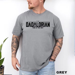A man wearing a grey t-shirt with the text "THE DADALORIAN THIS IS THE WAY" printed on it.