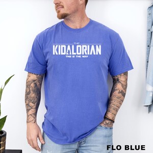 A man wearing a blue t-shirt with the text "THE KIDALORIAN THIS IS THE WAY" printed on it.