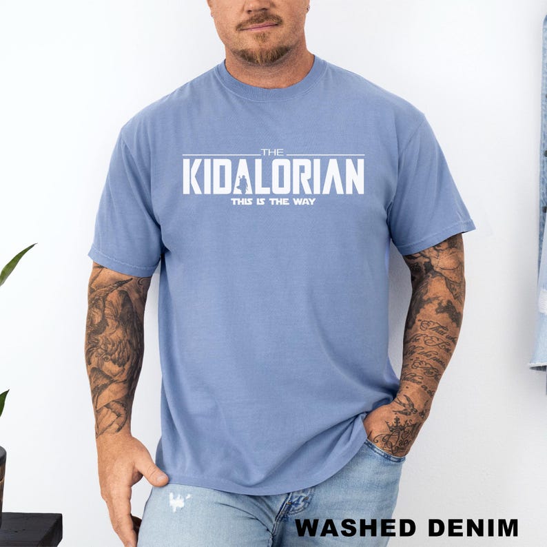 A man wearing a blue t-shirt with the text "THE KIDALORIAN THIS IS THE WAY" printed on it.