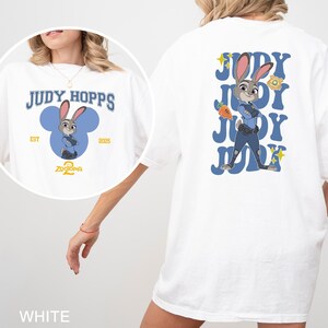 A white t-shirt with a graphic of a cartoon rabbit character and text related to the character Judy Hopps.
