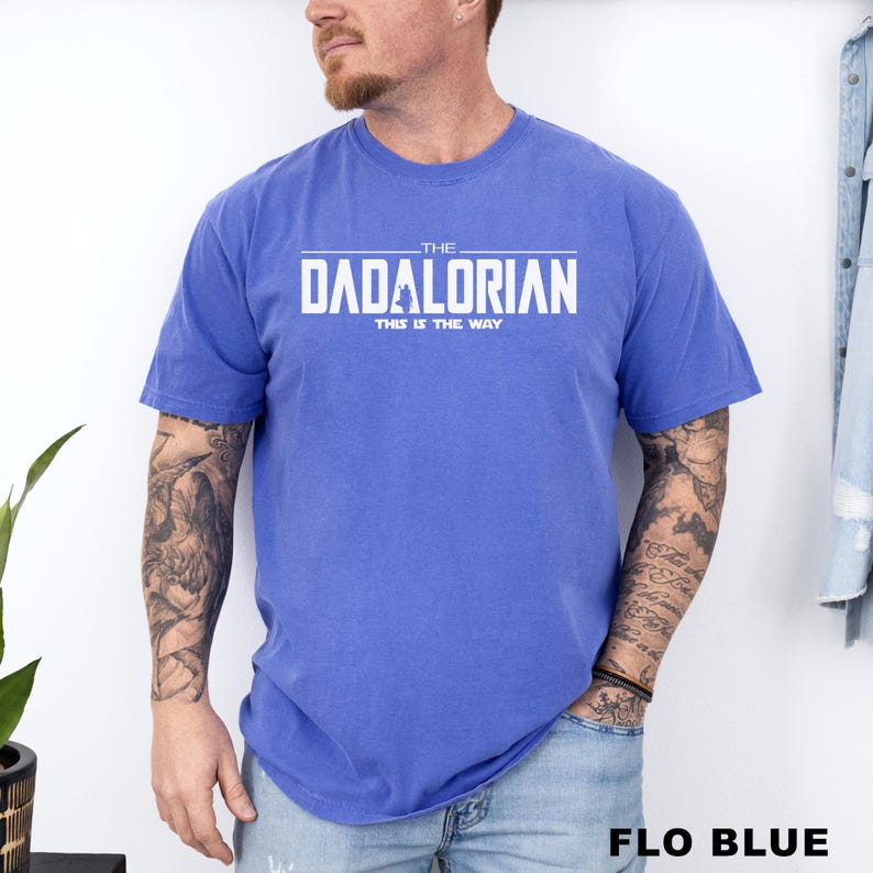 A man wearing a blue t-shirt with the text "THE DADALORIAN THIS IS THE WAY" printed on it.