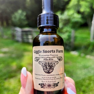 May include: A brown glass bottle with a black dropper top and a label that reads "Giggle Snorts Farm Wildcrafted Tincture Poke Root". The label also includes directions for use and ingredients, which are "Place 1 dropperful under tongue or in glass of water. Ingredients: Organic Cane Alcohol, Poke Root & Pure Love!"