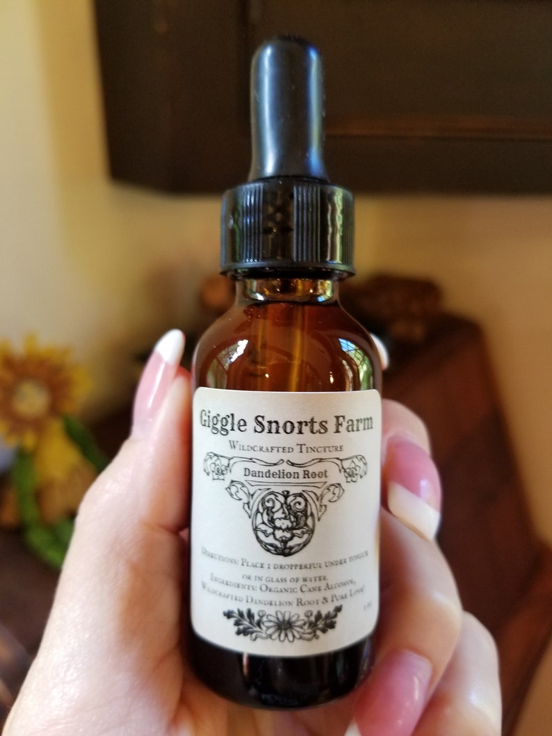 May include: A glass bottle with a dropper top and a white label that reads "Giggle Snorts Farm Wildcrafted Tincture Dandelion Root". The label also includes instructions for use and a list of ingredients.