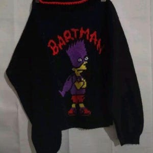 May include: Black knit sweater with a red trim around the neck. The sweater features a Bart Simpson graphic in purple, yellow, and red, with the word "BARTMAN" in red above the character.