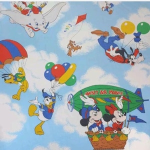 May include: A whimsical pattern featuring Disney characters in flight against a blue sky with clouds. Dumbo the elephant, Pluto with a parachute, Donald Duck with balloons, Goofy with balloons, and Mickey and Minnie Mouse in a hot air balloon are depicted.