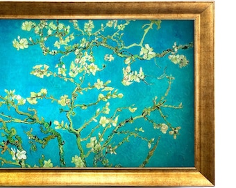 May include: A rectangular framed painting featuring white almond blossoms on thin brown branches against a vibrant turquoise blue background. The artwork is encased in a wide, ornate gold-colored frame with a textured, metallic finish.