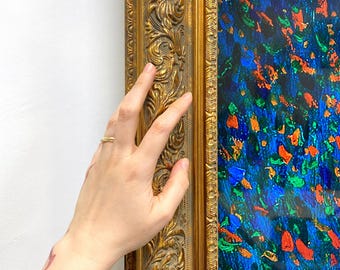 May include: A rectangular painting featuring a vibrant abstract composition of blue, green, and orange paint strokes, encased in an ornate, metallic gold-colored frame with intricate raised floral and scrollwork relief patterns throughout.