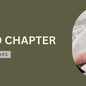 May include: An olive green banner with the text "SECOND CHAPTER" and "STYLE THAT SPEAKS". A close-up of a light gray button-down shirt with a cufflink is in a circular frame. The words "Tap to Explore" are at the bottom.