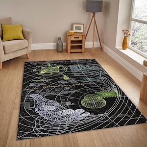 May include: Black area rug with a detailed, technical design featuring a wireframe hand, geometric shapes, and text. The rug has a dark background with white, green, and blue accents, creating a unique, artistic look.