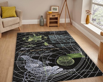 May include: Black area rug with a detailed, technical design featuring a wireframe hand, geometric shapes, and text. The rug has a dark background with white, green, and blue accents, creating a unique, artistic look.