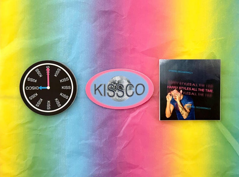 May include: A collection of stickers featuring a disco ball, a clock with "Disco Kiss" text, and a square sticker with the text "Harry Styles All The Time". The stickers are on a rainbow-colored background.