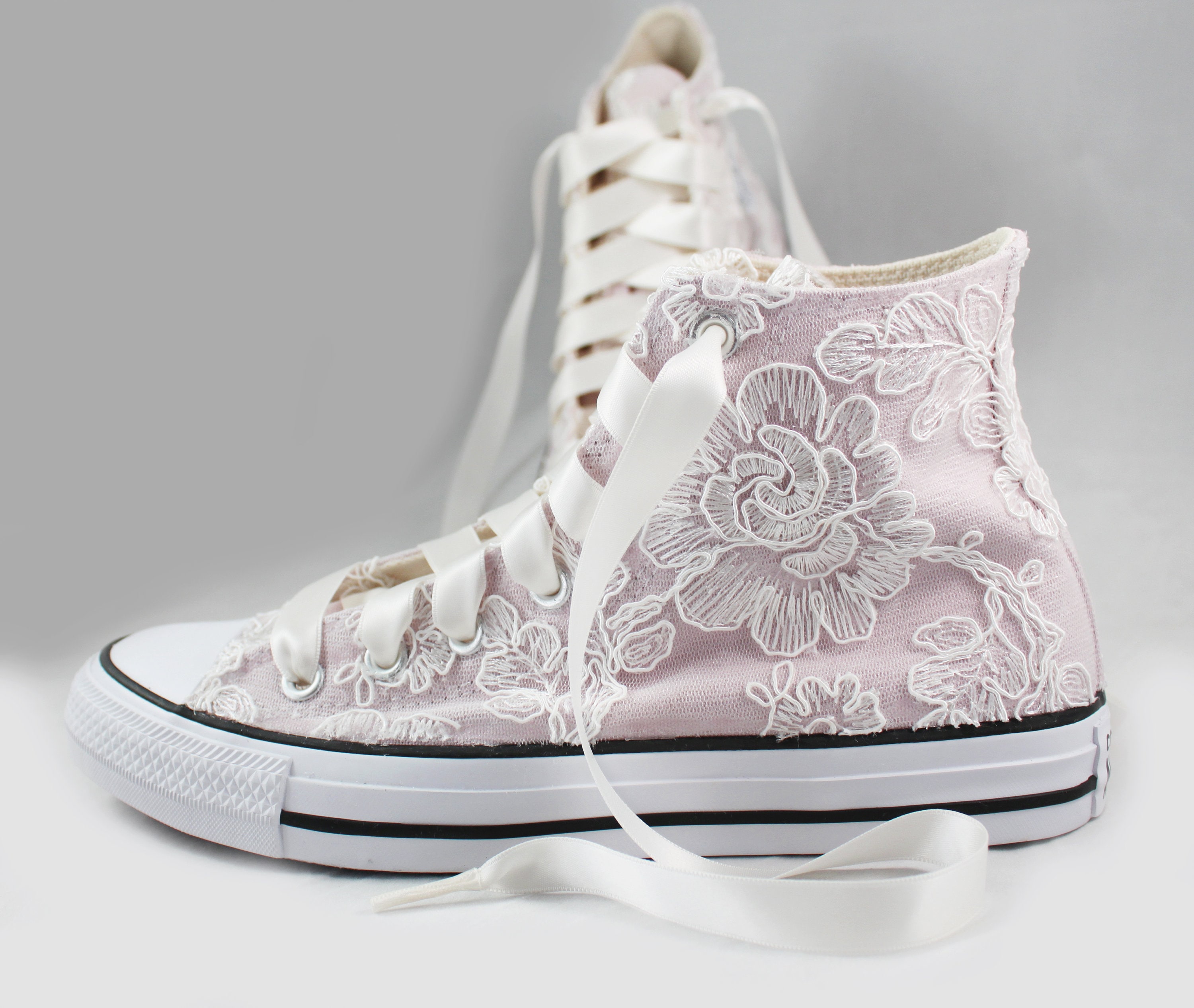 beige converse with flowers