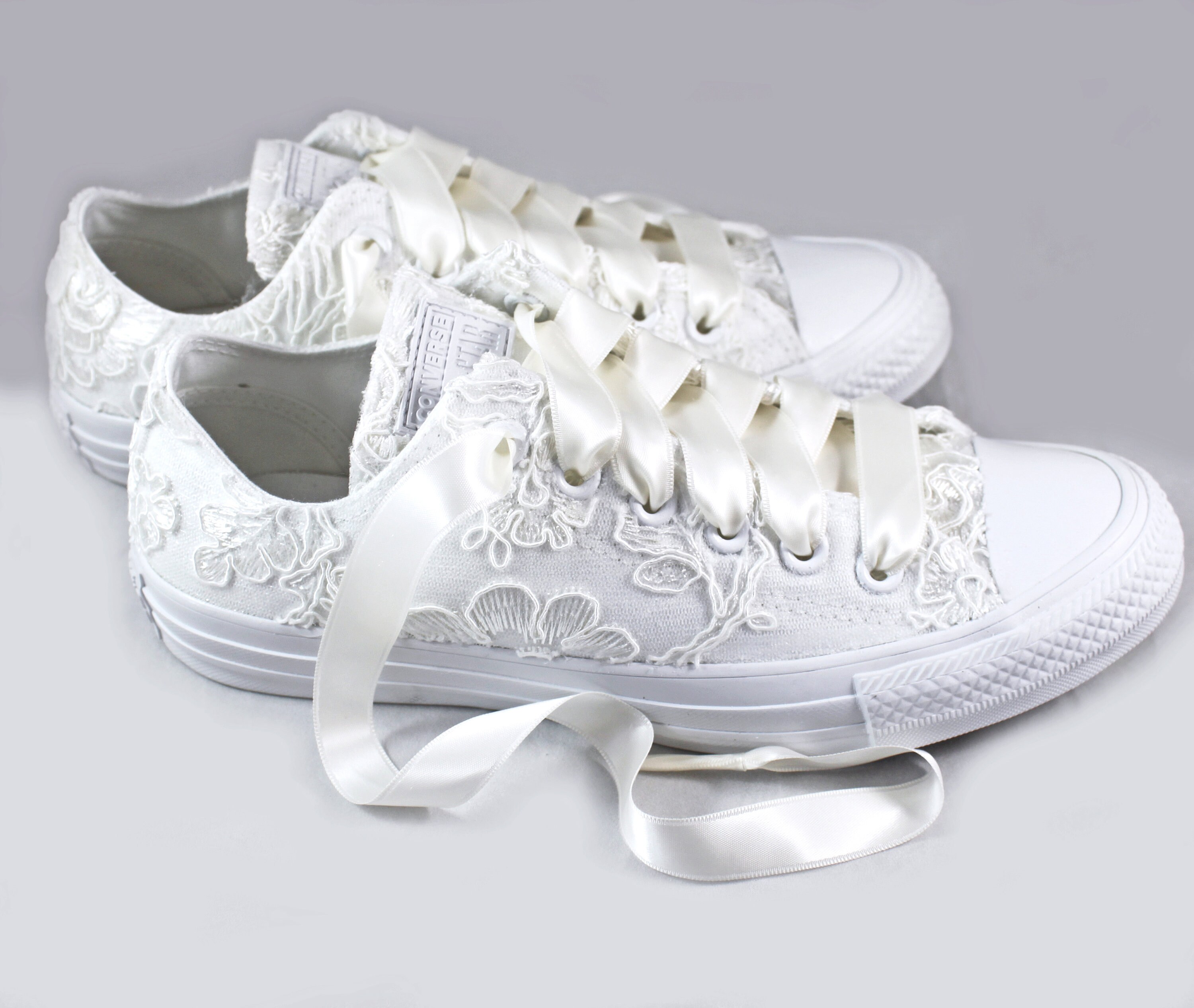 beige converse with flowers