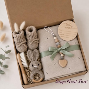 Curated newborn baby gift box with soft neutral and sage details, cozy baby essentials, bunny-inspired keepsakes, and thoughtful gifts for new parents. A beautiful baby shower gift basket, welcome baby gift box, new baby gift basket, new mom gift box, mom and baby gift, postpartum gift basket, and gender neutral baby gift for a newborn baby boy or girl.