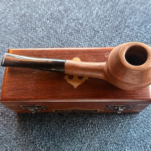 Dark walnut wooden tobacco pipes, hand carved emblems, made to order.