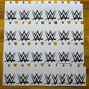 May include: A collection of white rectangular cards, each featuring a black WWE logo and a corresponding letter of the alphabet. The cards are arranged in a grid, with letters A through Z displayed.