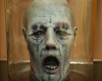 Life Sized Severed Head in an Apothecary Style Glass Jar.