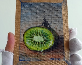 Loving Kiwi fruit. Miniature oil-painting on handmade canvas panel. Soft  colors. Tiny wall art, a small human figure and green kiwi fruit.