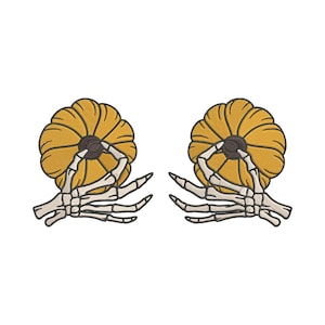 May include: Two embroidered patches featuring a yellow pumpkin held by a skeleton hand. The pumpkins have brown stems and are outlined in black. The skeleton hands are white and detailed, set against a white background.