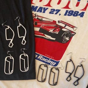 May include: A set of three ceramic mugs with a speckled, matte finish. The mugs are in shades of cream, light gray, and dark gray. Each mug has a simple, minimalist design, perfect for coffee or tea.