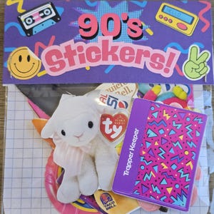 May include: A clear plastic bag containing a collection of 90's stickers and memorabilia. Includes a plush lamb, a Trapper Keeper, and stickers with a smiley face, cassette tape, and a peace sign. The top banner reads "90's Stickers!"