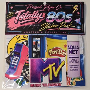 May include: A sticker pack titled "Totally 80s" by Pressed Paper Co. featuring retro designs. Stickers include a pink and purple phone, a yellow Play-Doh container, an MTV logo, and Aqua Net hairspray. The pack is part of the Nostalgia Collection.