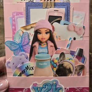 May include: A pink Y2K-themed paper craft with a Bratz doll, a Hello Kitty, a French bulldog, and other decorative elements. The craft includes a pink beanie, a butterfly, and a vanilla-flavored drink.