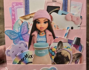 May include: A pink Y2K-themed paper craft with a Bratz doll, a Hello Kitty, a French bulldog, and other decorative elements. The craft includes a pink beanie, a butterfly, and a vanilla-flavored drink.