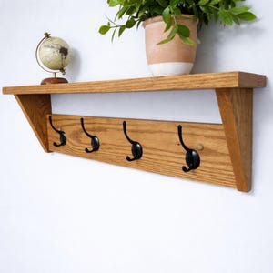 May include: A set of three ceramic mugs with a speckled, matte finish. The mugs are in shades of cream, light gray, and dark gray. Each mug has a simple, minimalist design, perfect for coffee or tea.