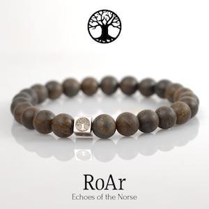 May include: A beaded bracelet with dark brown, round beads and a silver square accent bead featuring a tree design. The bracelet is displayed on a white surface with the text "RoAr" and "Echoes of the Norse" below.