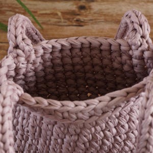 Handmade crochet tote bag pattern finished in thick t-shirt yarn showing sturdy structure and rounded shape