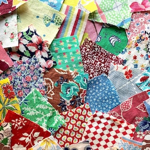 May include: A collection of colorful fabric scraps with various floral, geometric, and patterned designs. The fabrics feature a mix of colors, including red, blue, green, yellow, and pink. The image showcases a variety of textures and styles, perfect for quilting or crafting projects.
