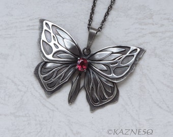 Oxidized silver butterfly pendant necklace with Rhodolite garnet.