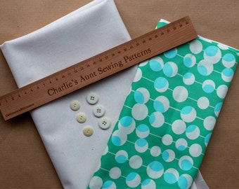 Lovely quality cotton canvas fabric in buttercream plus retro patterned cotton fabric in green and cream, and six vintage buttons