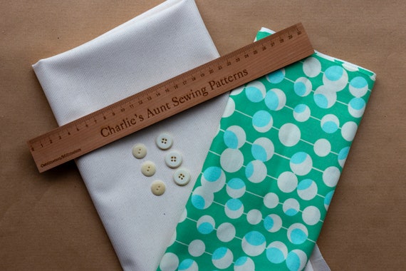 Lovely quality cotton canvas fabric in buttercream plus retro patterned cotton fabric in green and cream, and six vintage buttons