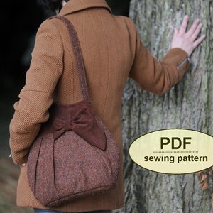 May include: A brown tweed tote bag with a large brown suede bow. The bag has a long brown strap and is being worn by a person in a brown coat. The text "PDF sewing pattern" is visible in the image.