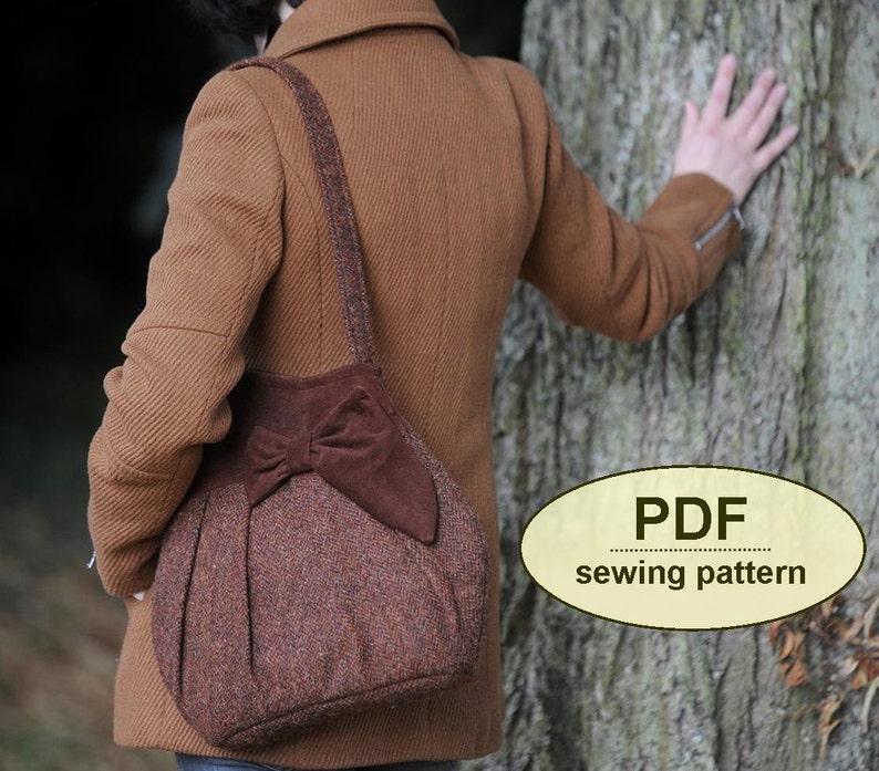 May include: A brown tweed tote bag with a large brown suede bow. The bag has a long brown strap and is being worn by a person in a brown coat. The text "PDF sewing pattern" is visible in the image.