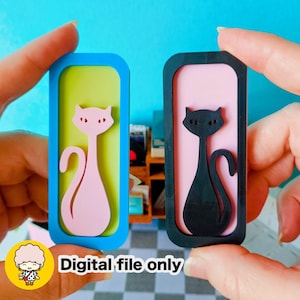 May include: Two cat-shaped bookmarks. One has a pink cat on a green background with a blue frame, the other has a black cat on a pink background with a black frame. The text "Digital file only" is at the bottom.