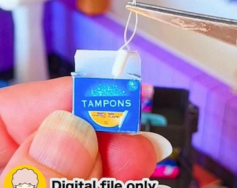 May include: Miniature blue box of tampons with the word "TAMPONS" in white. The box has a yellow and white design at the bottom and the text "100% NON PLASTIC". The text "Digital file only" is at the bottom.