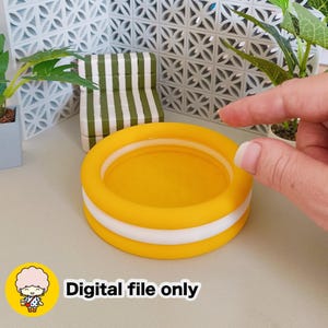 Puede incluir: Una piscina inflable amarilla y blanca en miniatura con interior amarillo. La piscina es redonda y tiene una franja blanca en el medio. El texto "Digital file only" se muestra en texto blanco en la esquina inferior derecha de la imagen.