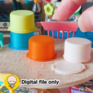 May include: Miniature colorful plastic containers in yellow, blue, orange, and white, with a matching lid. The containers are arranged on a small table. Text on the image reads "Digital file only."