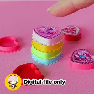 May include: A stack of heart-shaped boxes in white, yellow, green, and blue, with a floral design on top. The boxes have scalloped edges. The text "Digital file only" is displayed on the bottom of the image. Other heart-shaped objects are scattered around.