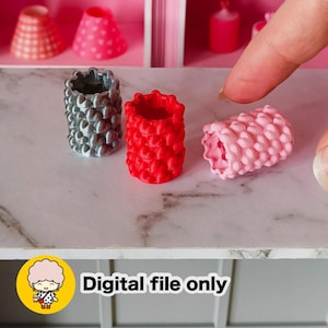May include: Three miniature, textured cylinders in gray, red, and pink. The cylinders have a repeating heart-shaped pattern. The image also includes the text "Digital file only" in white letters on a white background.