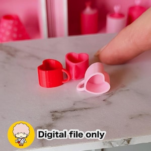May include: Three miniature heart-shaped mugs in red, pink, and light pink. The mugs have small handles and are arranged on a light-colored surface. The text "Digital file only" is visible in the image.