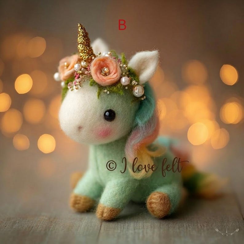 Op de afbeelding: Een handgemaakte vilten eenhoornfiguur in pastelgroen, met een gouden hoorn en een bloemenkrans. De eenhoorn heeft een regenboogmanen en -staart, en de tekst "&copy; I love felt" is zichtbaar.