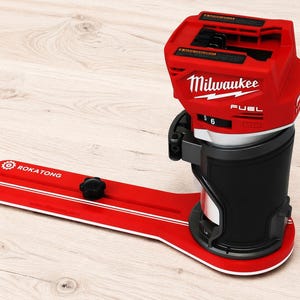 May include: A red and black Milwaukee Fuel power tool attached to a red Rokatong brand circular cutting guide base. The tool features a black grip, a red top housing with white text, and a long red extension arm with a black adjustment knob.