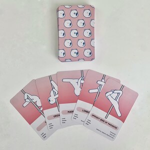 Examples of the deck of advanced red cards. The card back is red with a pattern of white polar bear faces. The cards fanned out feature white polar bears in various advanced poses on a red background.