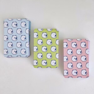 The backs of the three levels of card decks. Blue is for beginner, green is for intermediate, and red is for advanced.